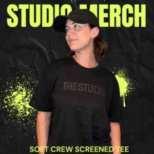 Woman wearing black t-shirt with black screen printing.