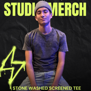 Model wearing distressed black tee with The Studio logo